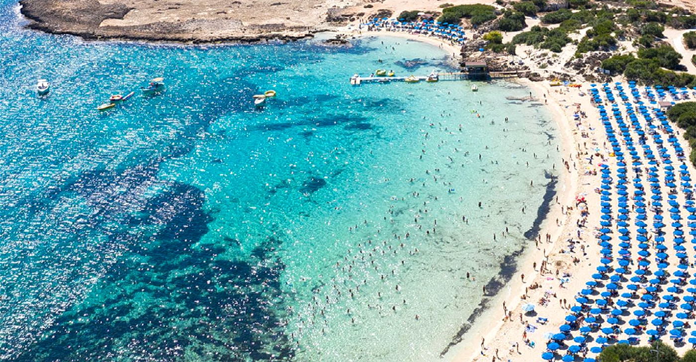 Makronissos Beach's connected coves of pale sand around a low peninsula west of Ayia Napa